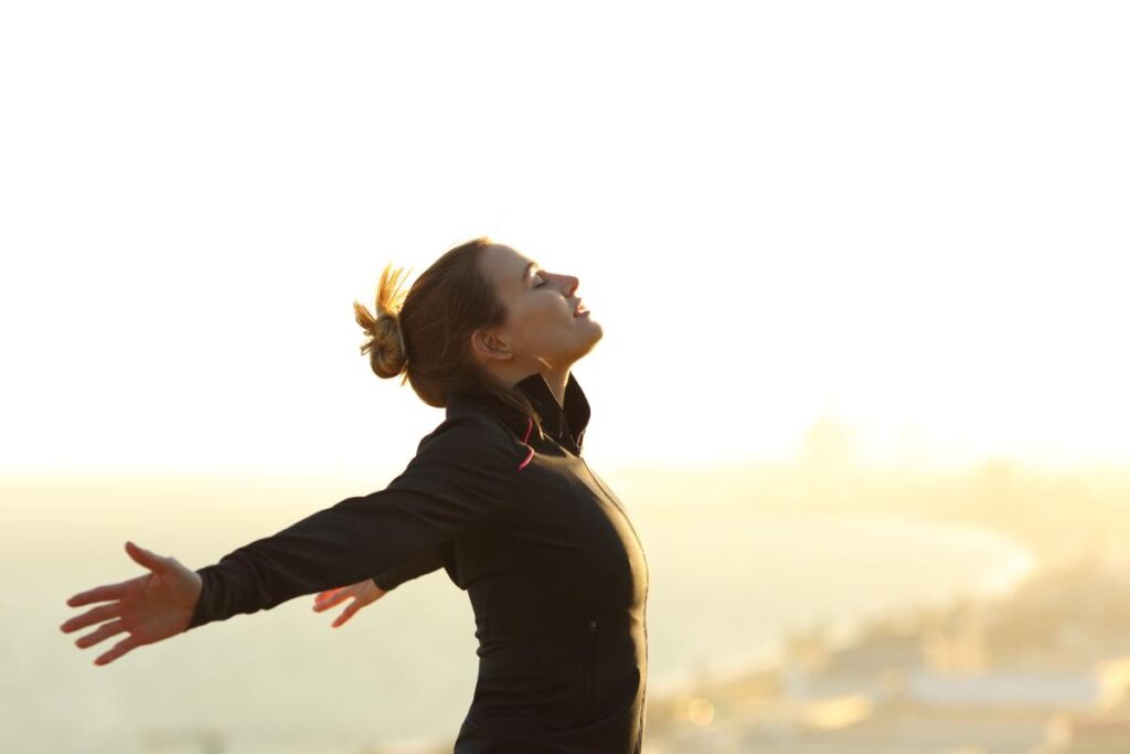 person stretching on beach while practicing self-care tips for mental health