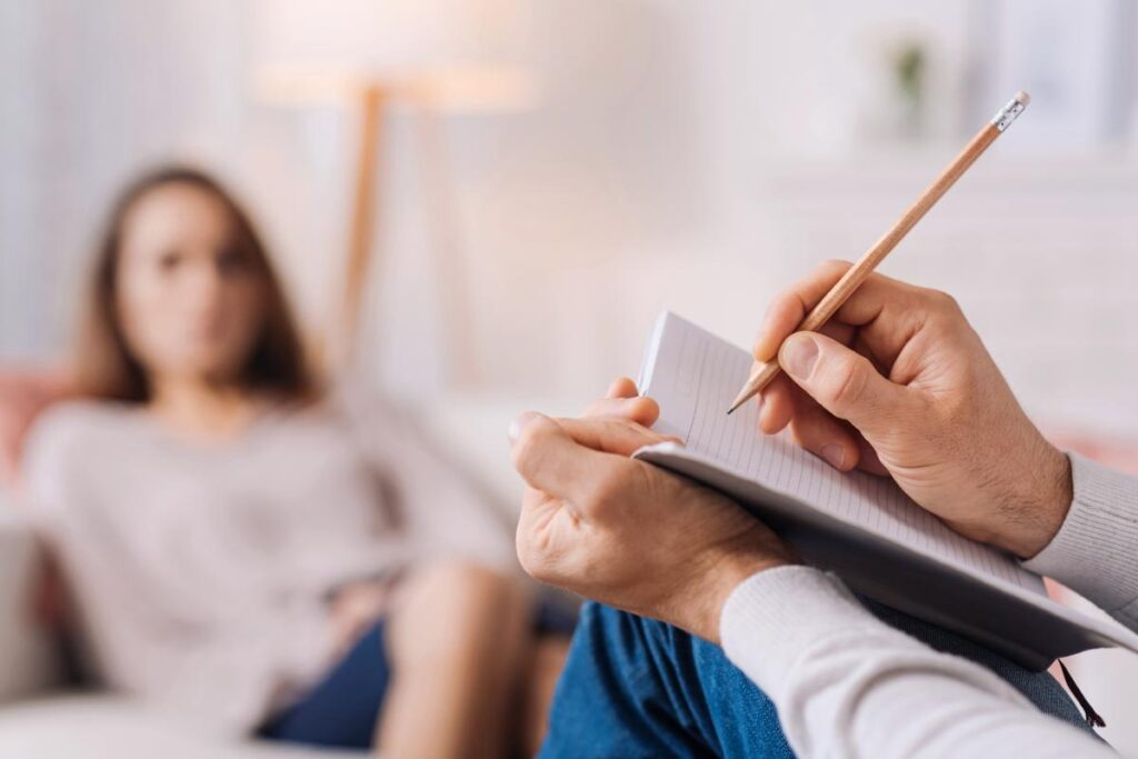 A therapist tells a woman about the benefits of inpatient treatment.