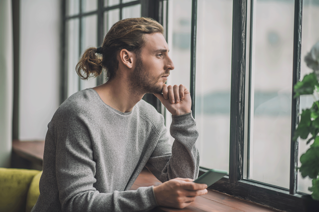 A man stares outside a window and wonders if he's addicted to antidepressants.